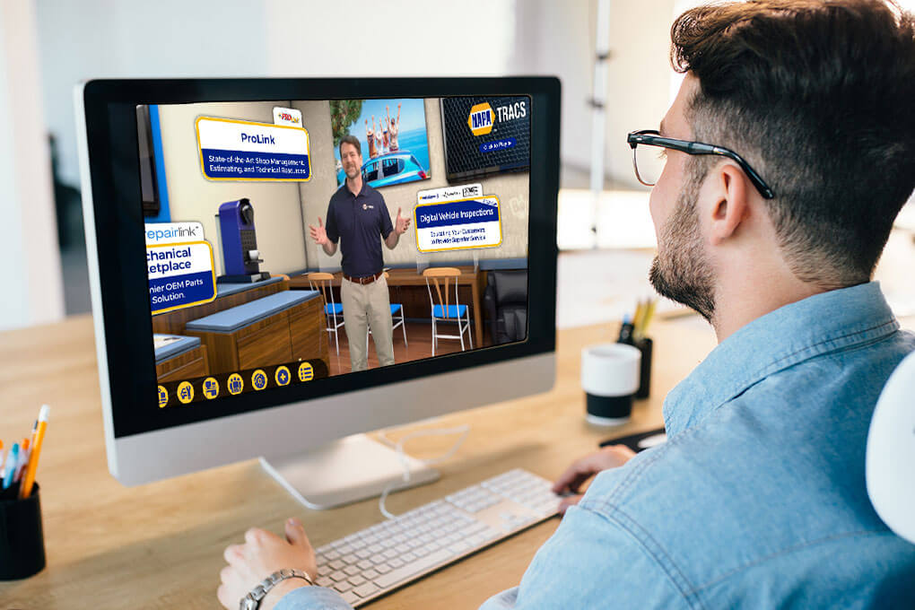 man looks at a computer screem with the NAPA Tracs 360 site on it with a man narrating